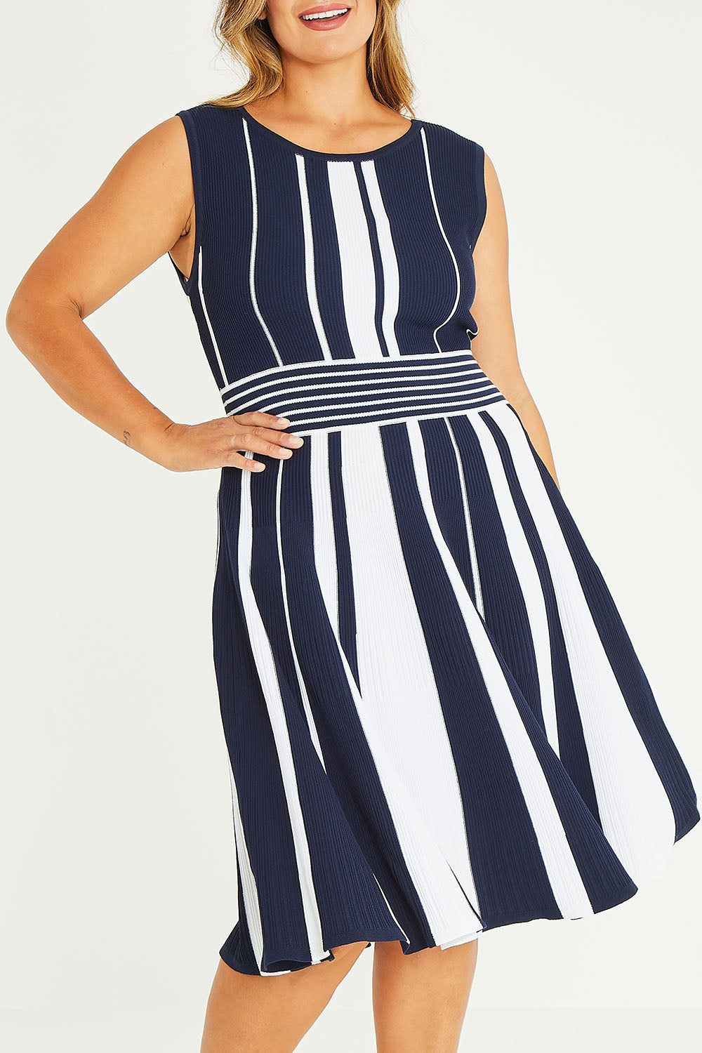 Model Palatina wearing size XL of The Reversible Knit Dress in colour Navystripe (Blue), from the front, cropped image