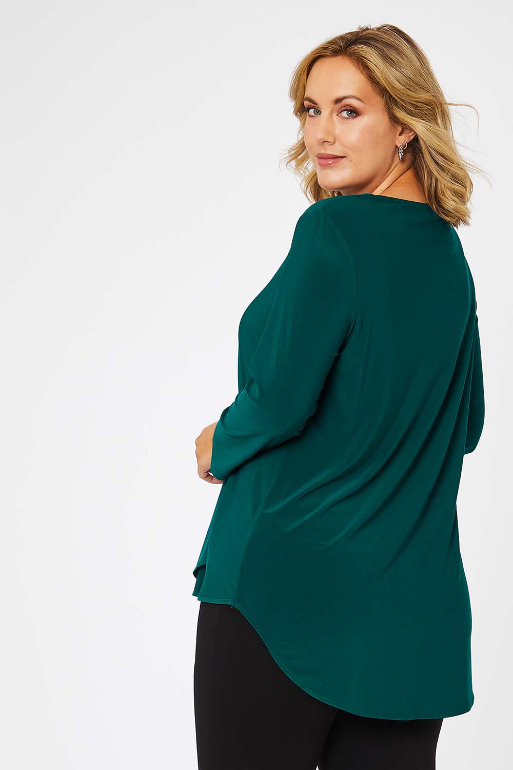Model Jess wearing size 14 of The Fold Detail Blouse in colour Forest (Green), from the back