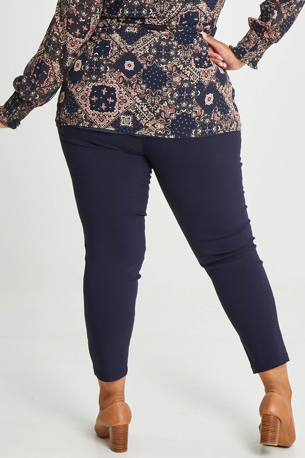 Model Alexis wearing size 16 of The Stretch Career Pull On Pant in colour Navy (Blue), from the back