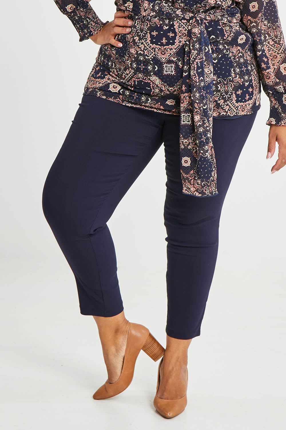 Model Alexis wearing size 16 of The Stretch Career Pull On Pant in colour Navy (Blue), from the front, cropped image
