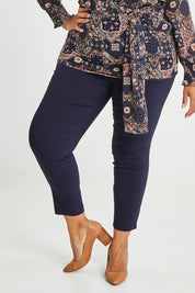 Model Alexis wearing size 16 of The Stretch Career Pull On Pant in colour Navy (Blue), from the front, cropped image