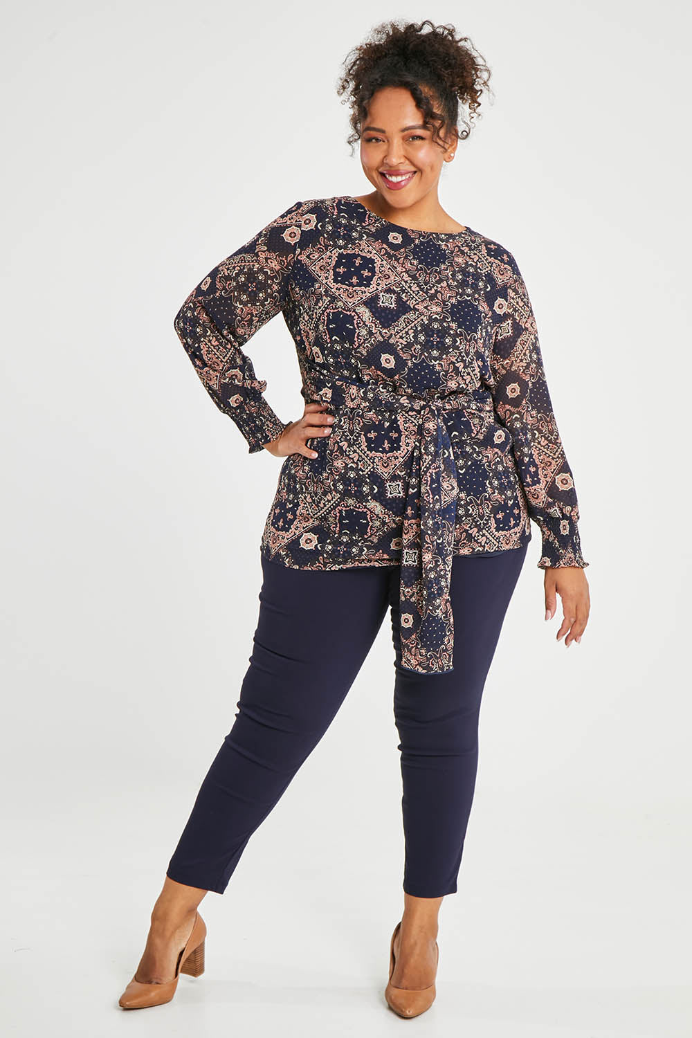 Model Alexis wearing size 16 of The Stretch Career Pull On Pant in colour Navy (Blue), from the front, showing the whole outfit