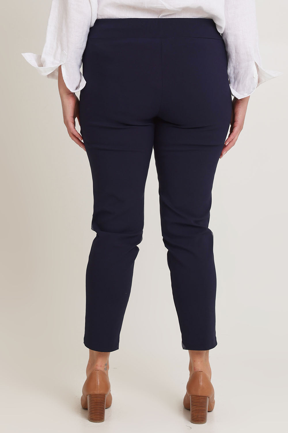 Model Chanel wearing size 16 of The Stretch Career Pull On Pant in colour Navy (Blue), from the back