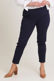 Model Chanel wearing size 16 of The Stretch Career Pull On Pant in colour Navy (Blue), from the front, cropped image