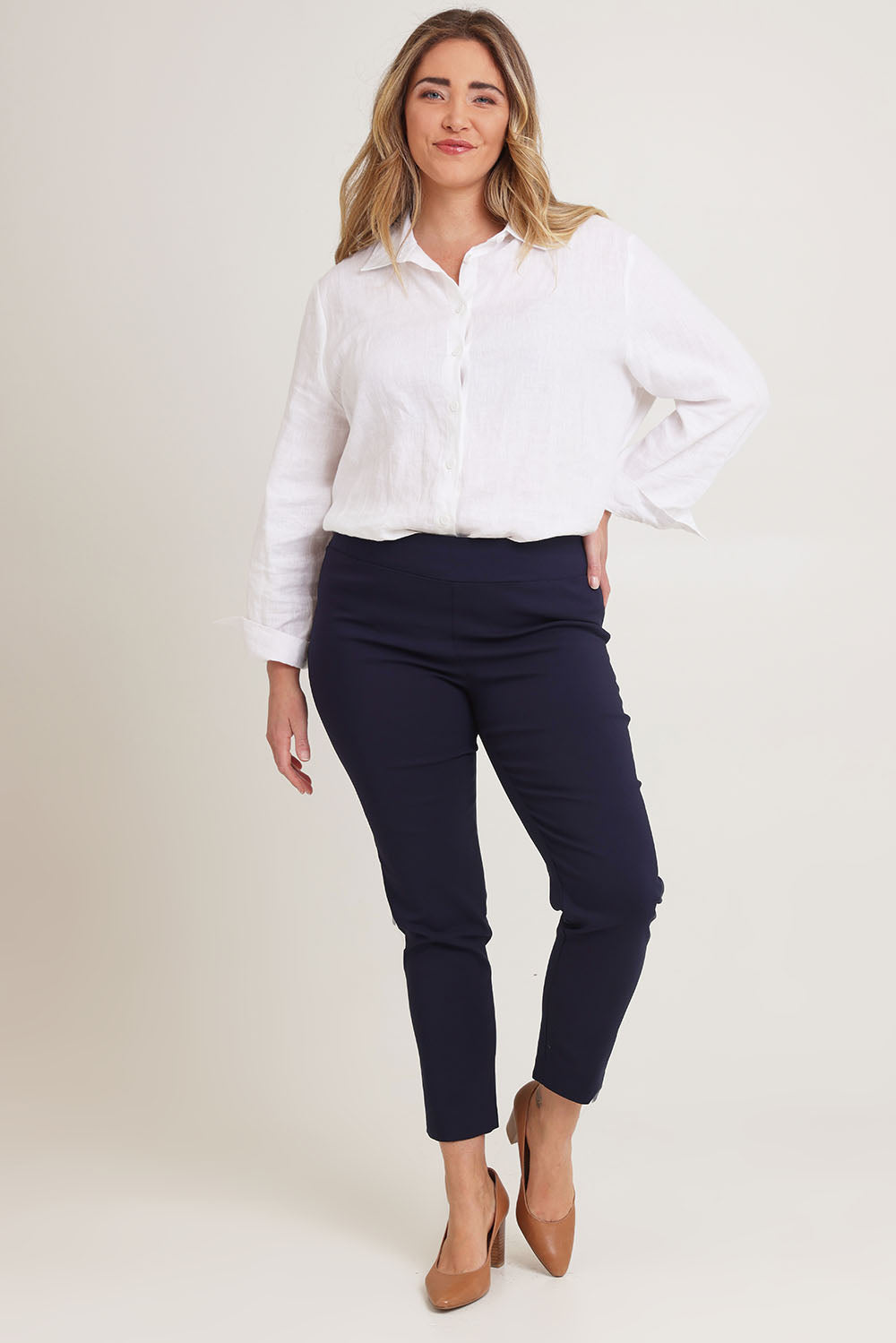 Model Chanel wearing size 16 of The Stretch Career Pull On Pant in colour Navy (Blue), from the front, showing the whole outfit
