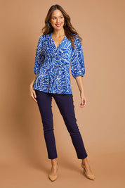 Model Madeline wearing size 10 of The Stretch Career Pull On Pant in colour Navy (Blue), from the front, showing the whole outfit
