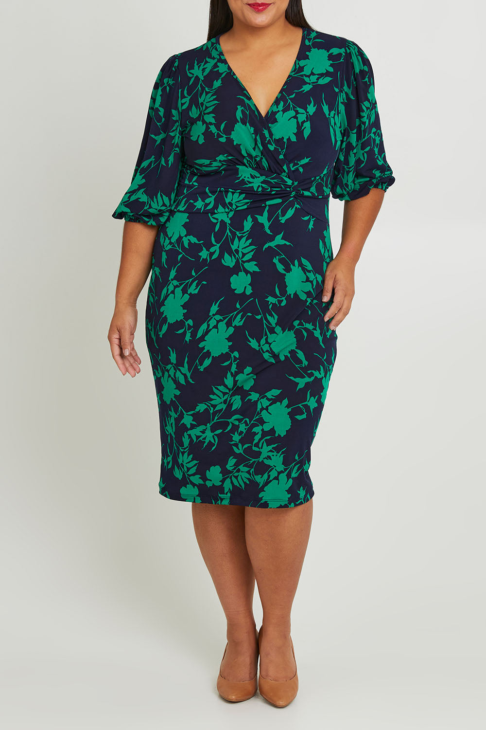 Model Ashleigh wearing size 16 of The Printed Knot Waist Detail Dress in colour Greenfleur (Green), from the front, cropped image