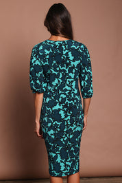 Model Amanda wearing size 10 of The Printed Knot Waist Detail Dress in colour Tealfleur (Green), from the back