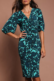 Model Amanda wearing size 10 of The Printed Knot Waist Detail Dress in colour Tealfleur (Green), from the front, cropped image