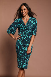 Model Amanda wearing size 10 of The Printed Knot Waist Detail Dress in colour Tealfleur (Green), from the front, cropped image