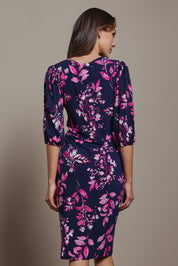 Model Madeline wearing size 10 of The Printed Knot Waist Detail Dress in colour Nightpetal (Blue), from the back
