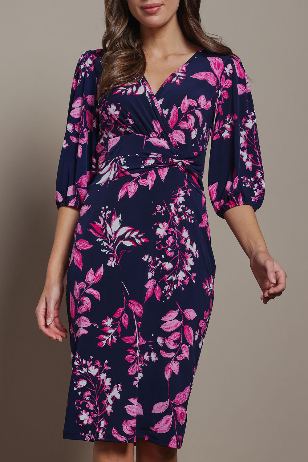 Model Madeline wearing size 10 of The Printed Knot Waist Detail Dress in colour Nightpetal (Blue), from the front, cropped image