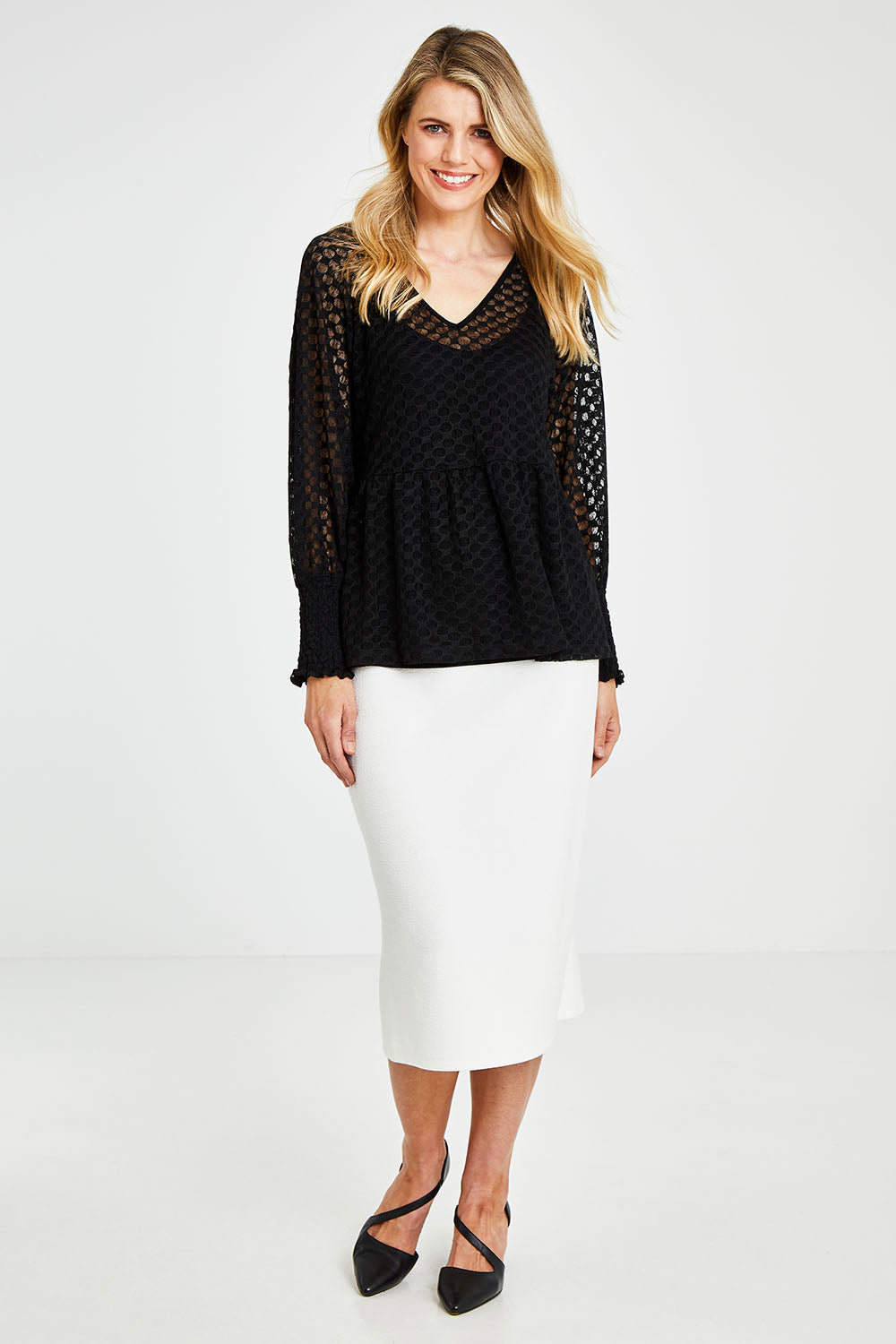 Model Kelly wearing size 10 of The Smocked Cuff Lace Blouse in colour Black (Black), from the front, showing the whole outfit
