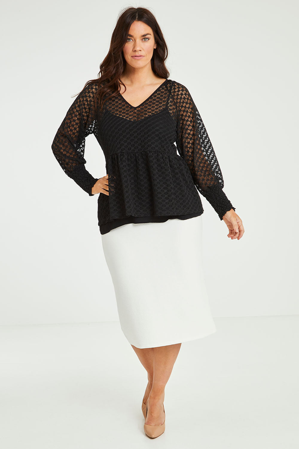 Model Laura wearing size 14 of The Smocked Cuff Lace Blouse in colour Black (Black), from the front, showing the whole outfit