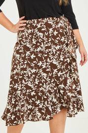 Model Katie wearing size 16 of The Lined Faux Wrap Ruffle Skirt in colour Vines, from the front, cropped image