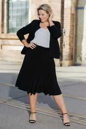 Model Fiona wearing size 16 of The Pull On Gore Skirt in colour Black (Black), from the front, showing the whole outfit