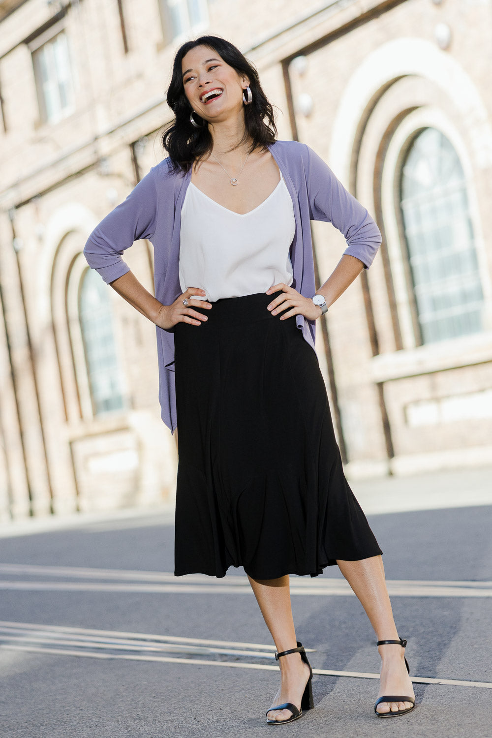 Model Miranda wearing size 10 of The Pull On Gore Skirt in colour Black (Black), from the front, showing the whole outfit