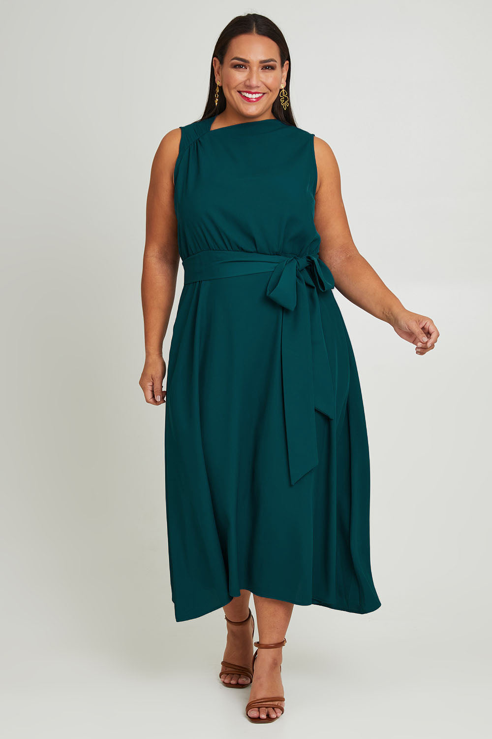 Model Ashleigh wearing size 16 of The Adore Dress in colour Jewel (Green), from the front, showing the whole outfit