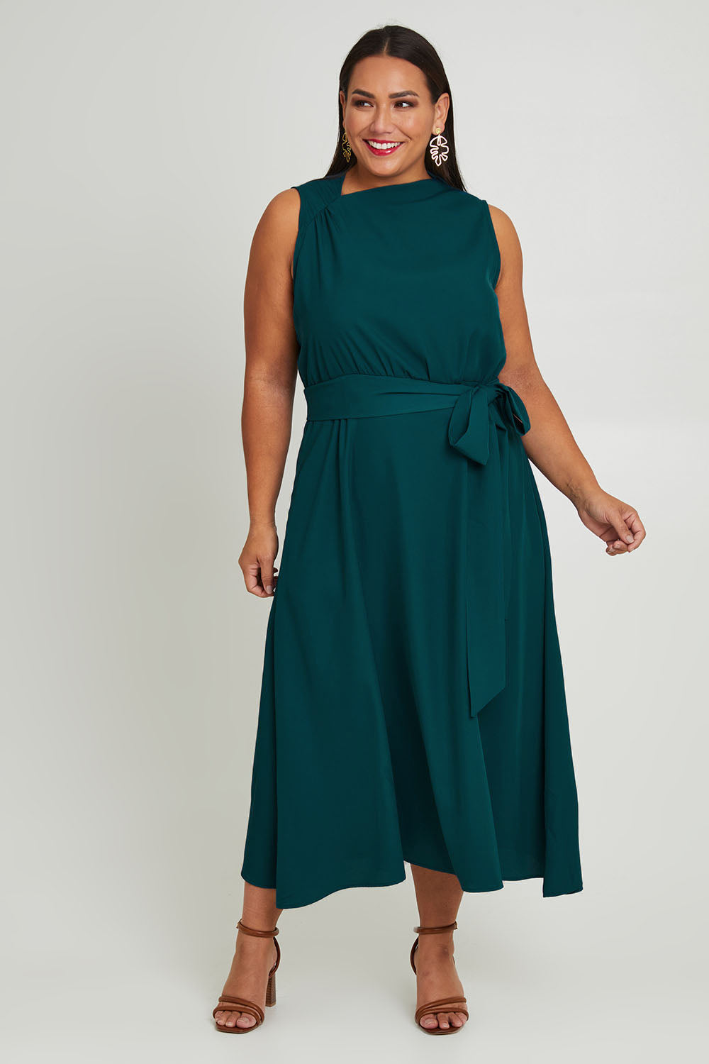 Model Ashleigh wearing size 16 of The Adore Dress in colour Jewel (Green), from the front, showing the whole outfit