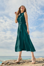 Model Clementine wearing size 10 of The Adore Dress in colour Jewel (Green), from the front, showing the whole outfit