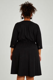 Model Alexis wearing size 16 of The Contemporary Lapel Dress in colour Black (Black), from the back