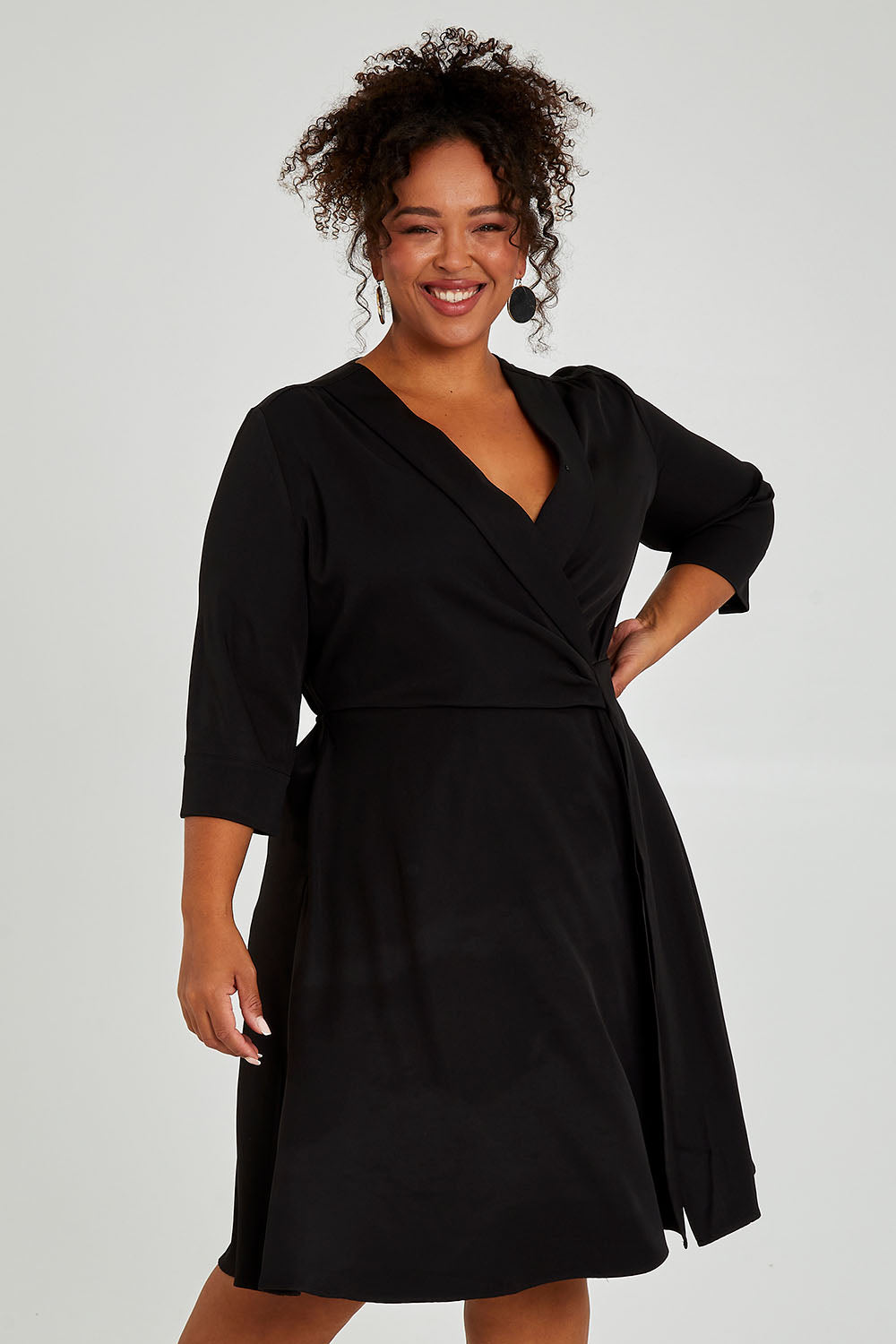 Model Alexis wearing size 16 of The Contemporary Lapel Dress in colour Black (Black), from the front, cropped image