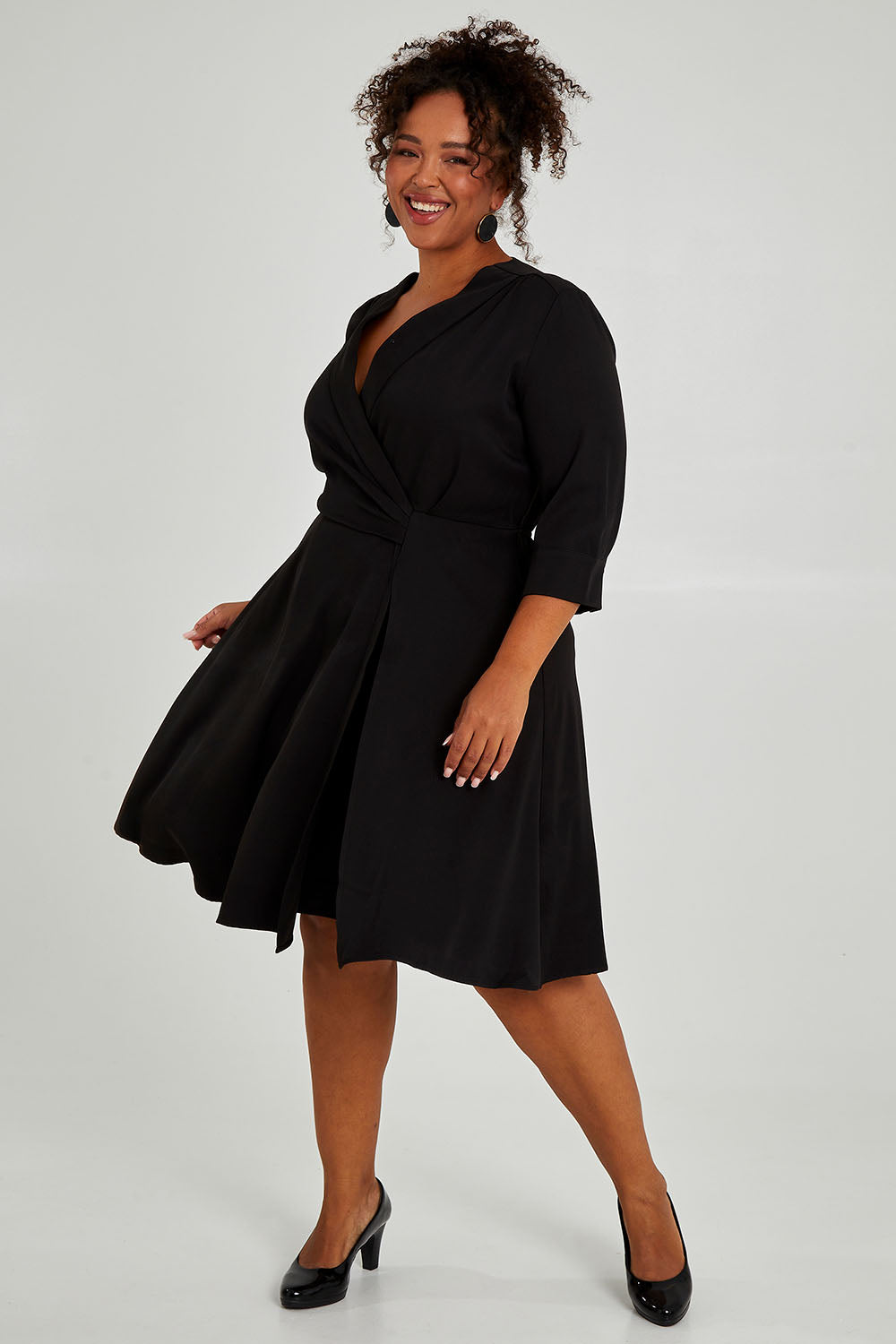 Model Alexis wearing size 16 of The Contemporary Lapel Dress in colour Black (Black), from the front, showing the whole outfit
