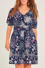 Model Laura wearing size 14 of The Ruched Waist Detail Dress in colour Garden (Blue), from the front, cropped image