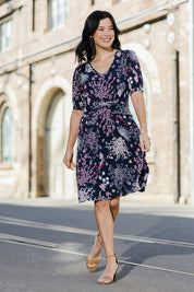 Model Miranda wearing size 10 of The Ruched Waist Detail Dress in colour Garden (Blue), from the front, showing the whole outfit