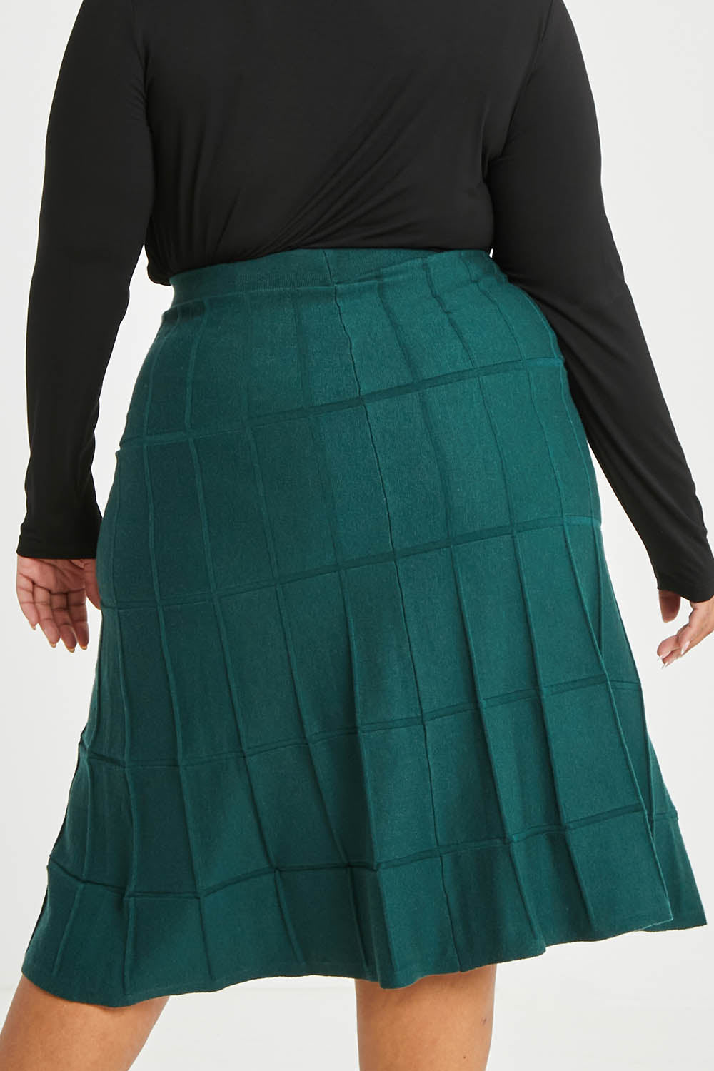Model Alexis wearing size XL of The Midi Textured Knit Skirt in colour Tealgreen (Green), from the back