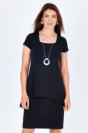 Model Rebecca wearing size 10 of The Short Sleeve Rita Dress in colour Black (Black), from the front, cropped image