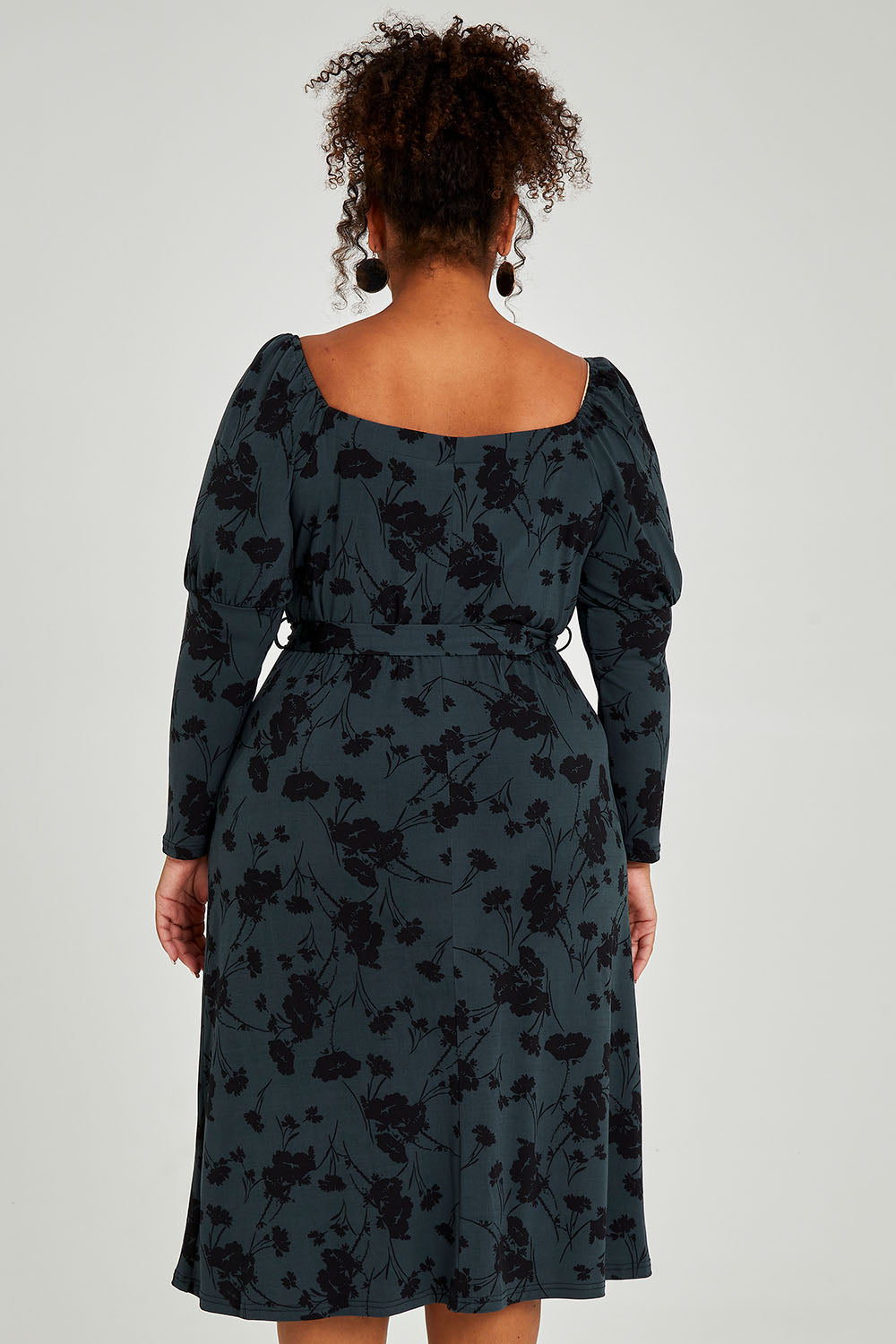 Model Alexis wearing size 16 of The Square Neck Dress in colour Poppy (Green), from the back