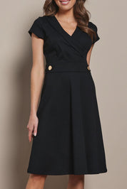 Model Madeline wearing size 10 of The Cap Sleeve Ponte Lapel Dress in colour Black (Black), from the front, cropped image