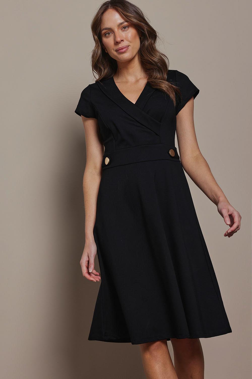Model Madeline wearing size 10 of The Cap Sleeve Ponte Lapel Dress in colour Black (Black), from the front, cropped image