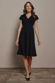 Model Madeline wearing size 10 of The Cap Sleeve Ponte Lapel Dress in colour Black (Black), from the front, showing the whole outfit