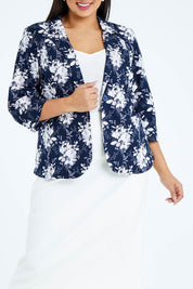 Model Sasha-Lee wearing size 16 of The Printed Cotton Pocket Blazer in colour Navyfleur (Blue), from the front, cropped image