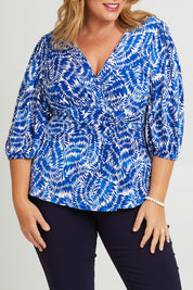 Model Fiona wearing size 16 of The Printed Knot Waist Detail Blouse in colour Fern (Blue), from the front, cropped image