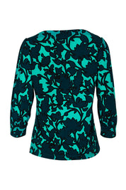 Product shot of The Printed Boat Neck Blouse in colour Tealfleur (Green), from the back