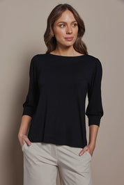 Model Madeline wearing size 10 of The Bamboo Boat Neck Top in colour Black (Black), from the front, cropped image