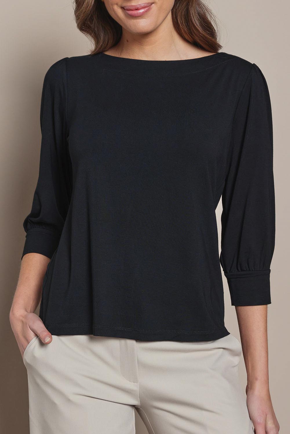 Model Madeline wearing size 10 of The Bamboo Boat Neck Top in colour Black (Black), from the front, cropped image