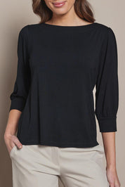 Model Madeline wearing size 10 of The Bamboo Boat Neck Top in colour Black (Black), from the front, cropped image