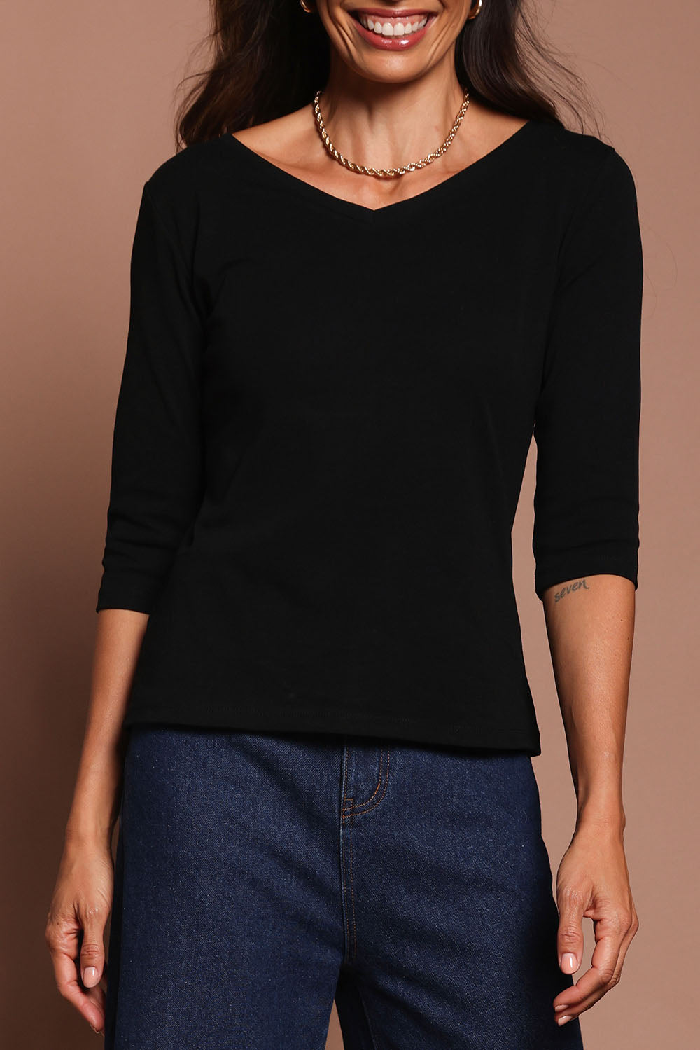 Model Amanda wearing size 10 of The Reversible Cotton Stretch Top in colour Black (Black), from the front, cropped image