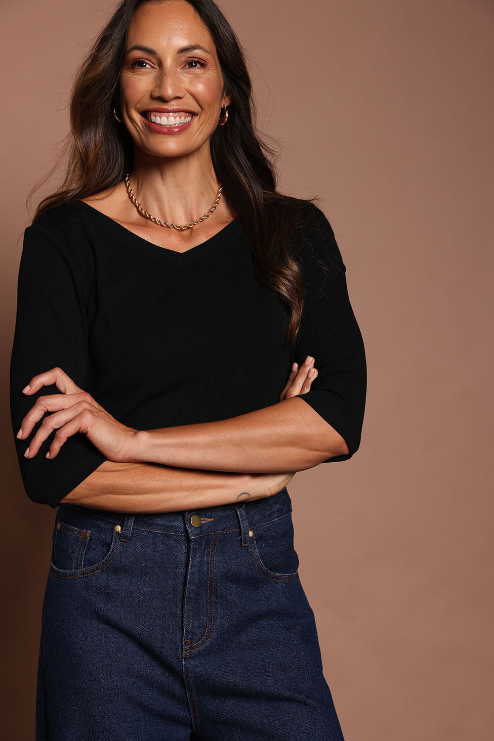 Model Amanda wearing size 10 of The Reversible Cotton Stretch Top in colour Black (Black), from the front, cropped image