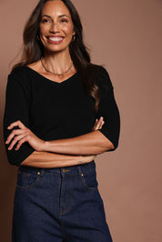 Model Amanda wearing size 10 of The Reversible Cotton Stretch Top in colour Black (Black), from the front, cropped image