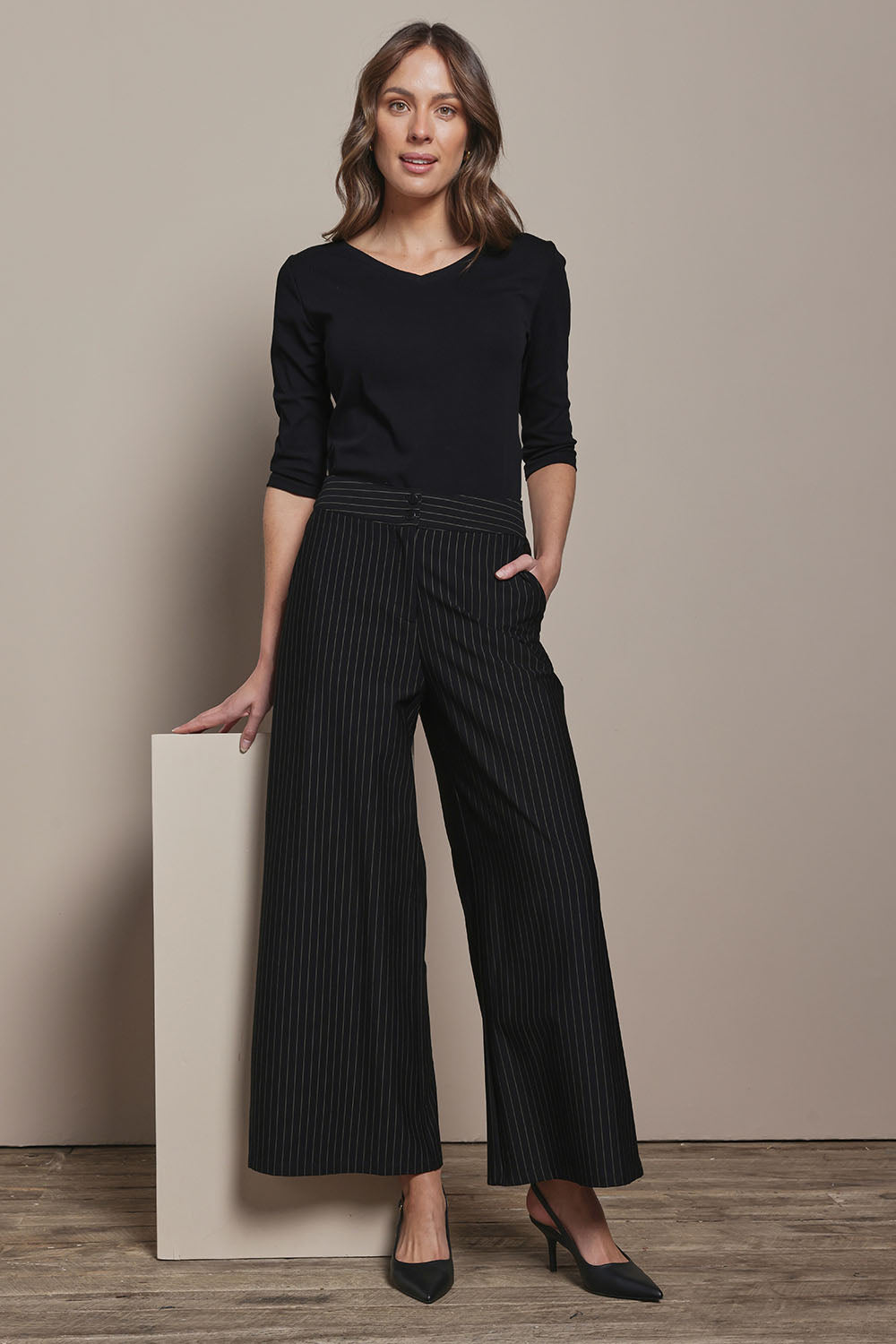 Model Madeline wearing size 10 of The Reversible Cotton Stretch Top in colour Black (Black), from the front, showing the whole outfit