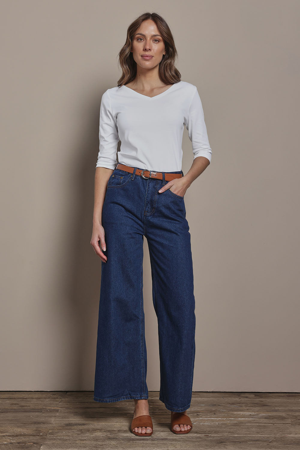 Model Madeline wearing size 10 of The Reversible Cotton Stretch Top in colour White (White), from the front, showing the whole outfit