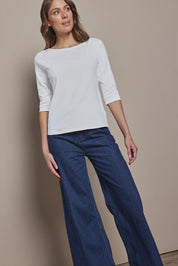 Model Madeline wearing size 10 of The Reversible Cotton Stretch Top in colour White (White), from the front, showing the whole outfit