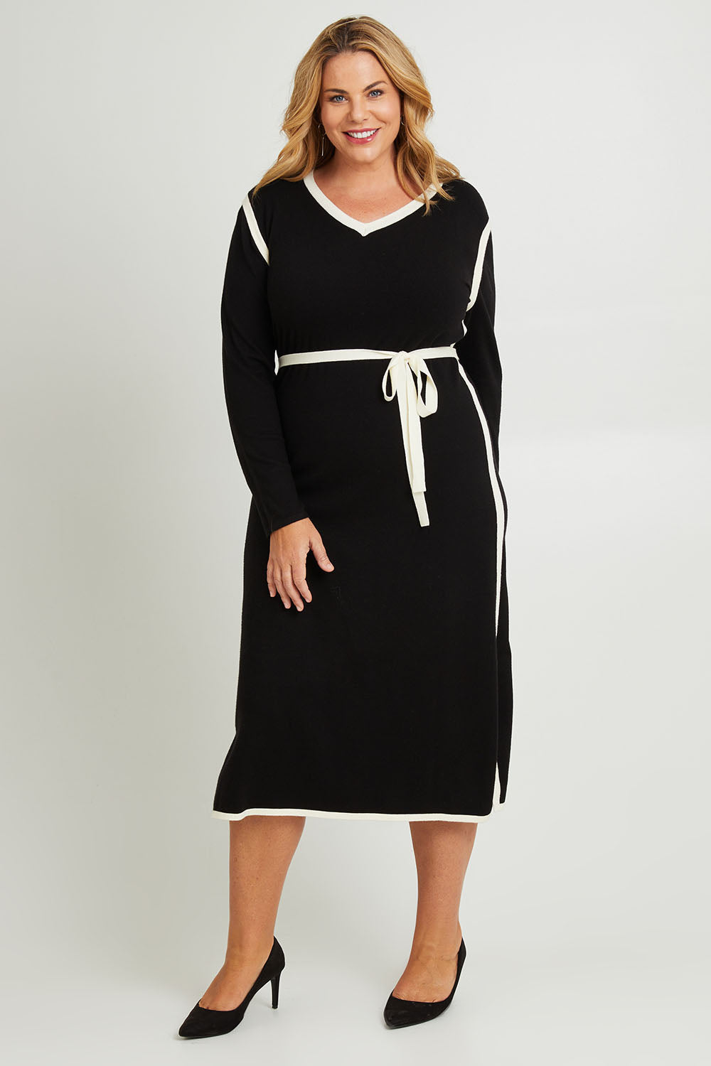 Model Fiona wearing size XL of The Reversible Contrast Detail Knit Dress in colour Black (Black), from the front, showing the whole outfit