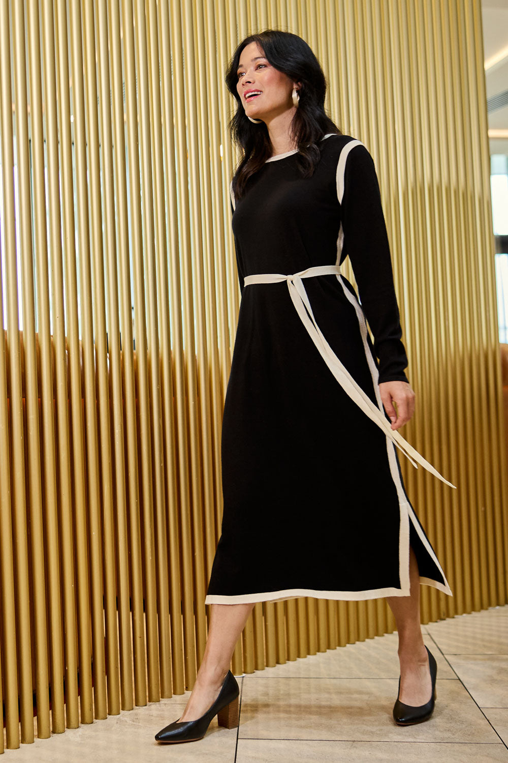Model Miranda wearing size S of The Reversible Contrast Detail Knit Dress in colour Black (Black), from the front, showing the whole outfit