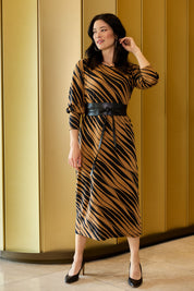 Model Miranda wearing size 10 of The Printed Knit Dress With Belt in colour Abstract (Black), from the front, showing the whole outfit